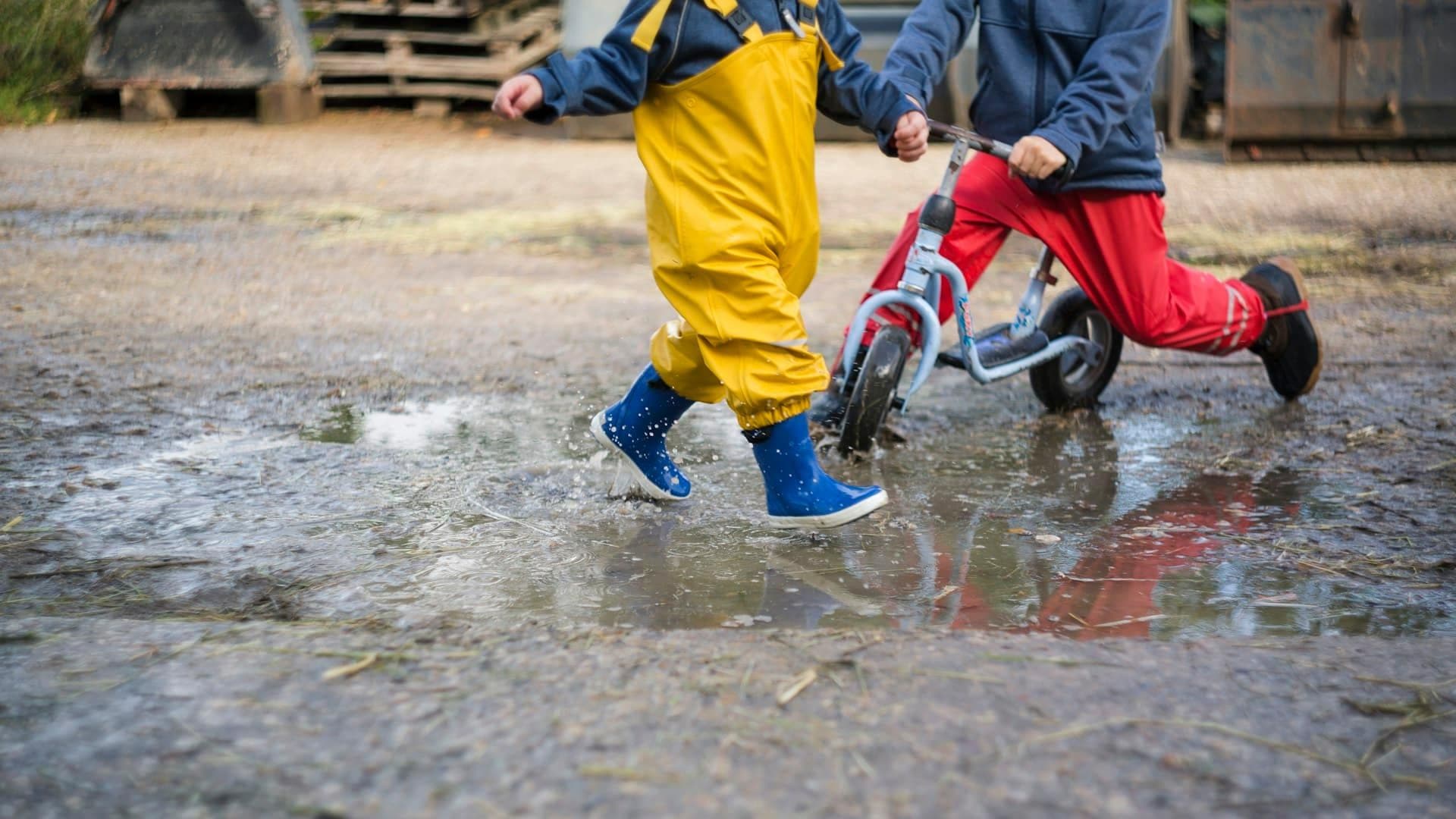 Kinderen fietsen in de regen